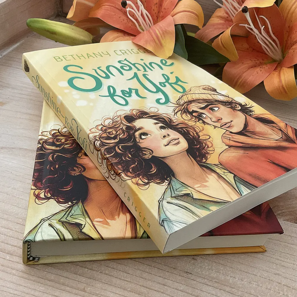 Sunshine for Yofi by Bethany Crigger, two printed editions stacked with orange lilies